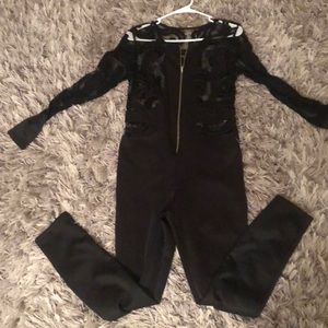 Katt Black jumpsuit with lace design.